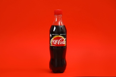 Photo of MYKOLAIV, UKRAINE - NOVEMBER 14, 2018: Bottle of Coca-Cola on color background