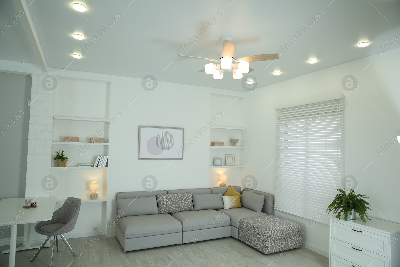 Photo of Ceiling fan, furniture and accessories in stylish living room