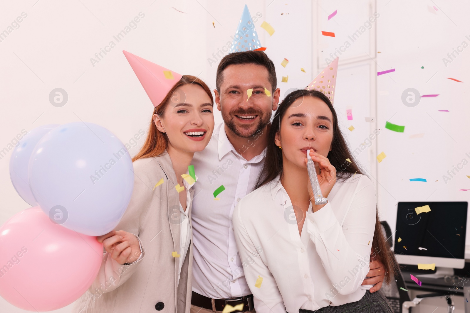 Photo of Coworkers having fun during office party indoors