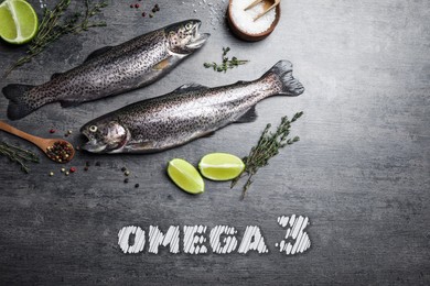 Image of Omega 3. Fresh fish, lime and spices on grey table, flat lay