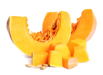 Pieces of ripe orange pumpkin and seeds on white background