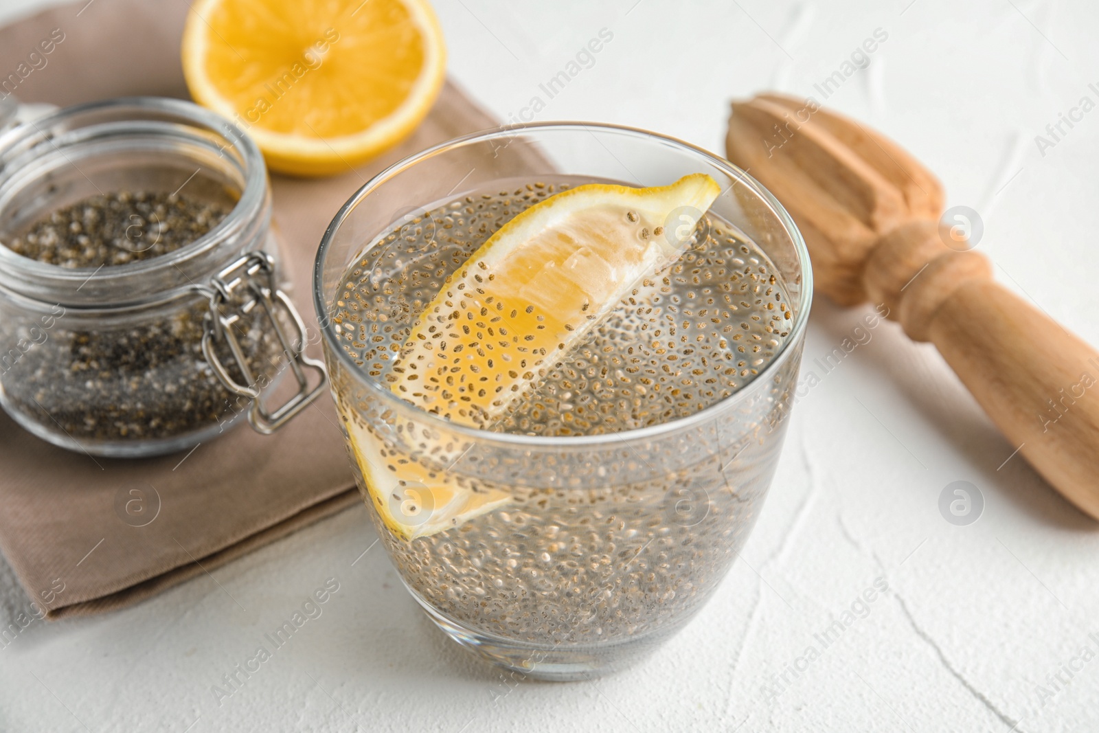 Photo of Composition with glass of water and chia seeds on white background