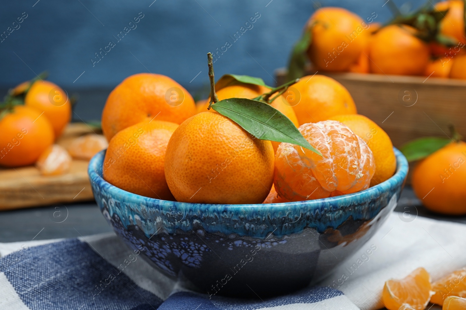 Photo of Fresh ripe tangerines in bowl on table