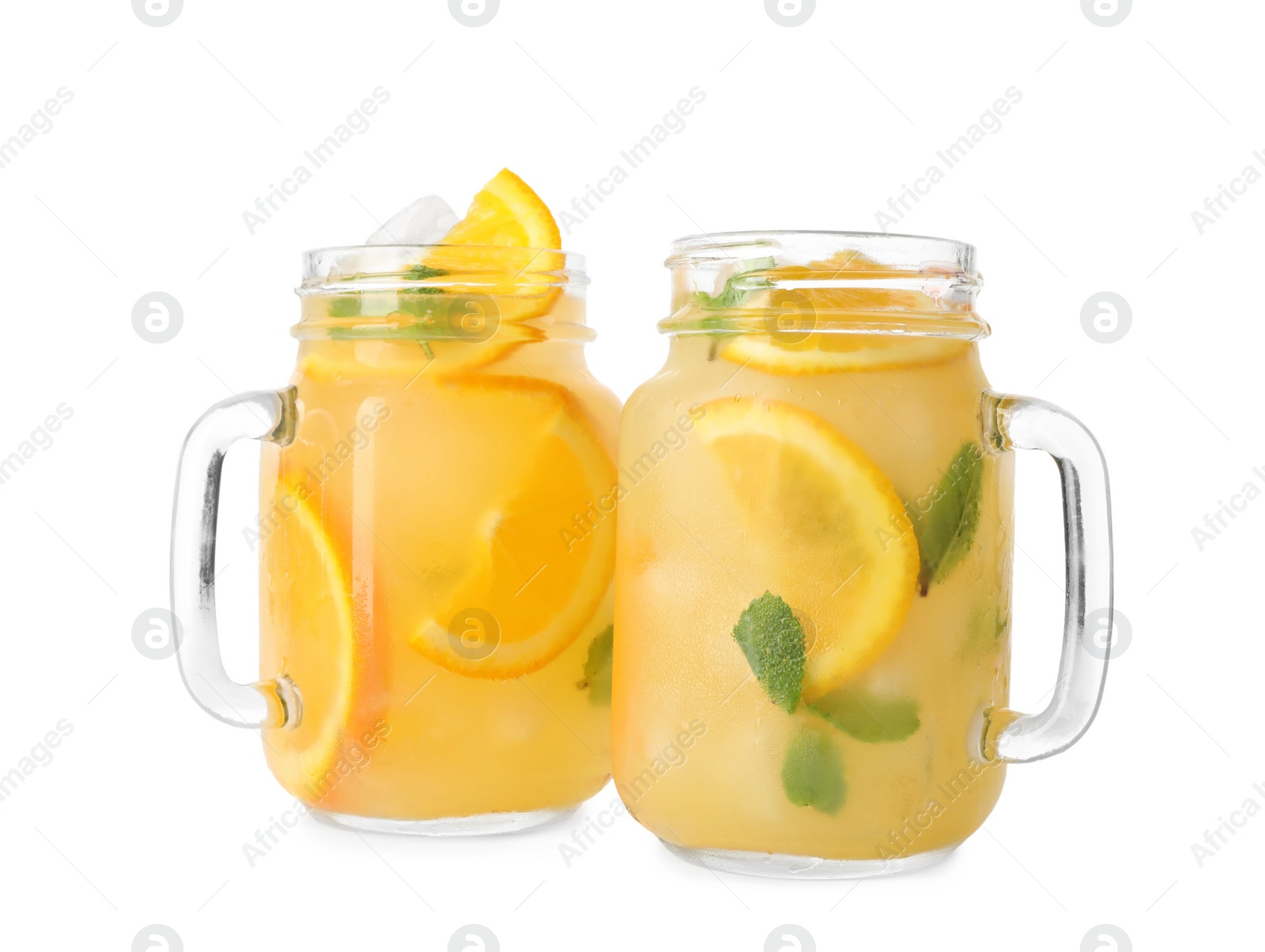 Photo of Mason jars with orange refreshing drink on white background