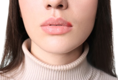 Young woman on white background, closeup. Focus on lips