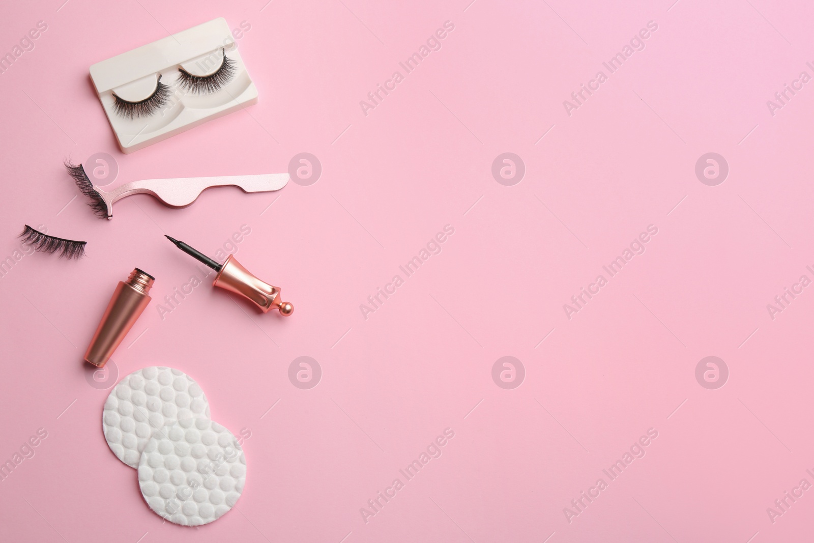 Photo of Flat lay composition with magnetic eyelashes and accessories on pink background. Space for text