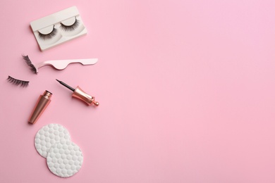 Flat lay composition with magnetic eyelashes and accessories on pink background. Space for text