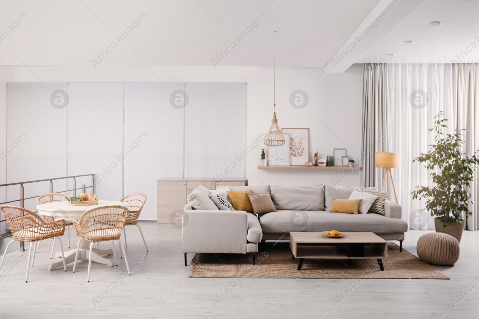 Photo of Stylish living room interior with comfortable grey sofa and coffee table