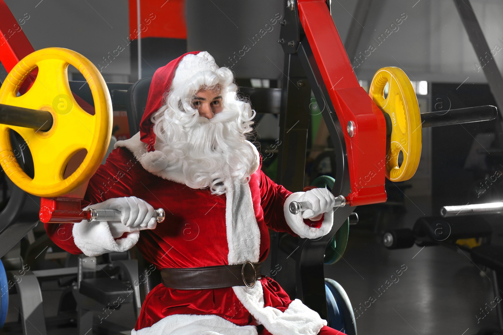 Photo of Young Santa Claus training in modern gym