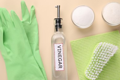 Photo of Eco friendly natural cleaners. Flat lay composition with bottle of vinegar on beige background