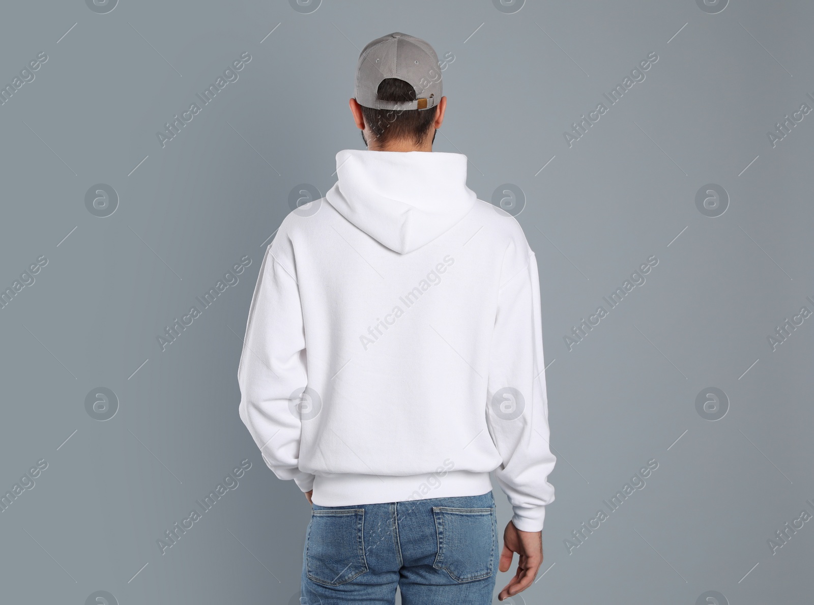 Photo of Young man in sweater on grey background. Mock up for design