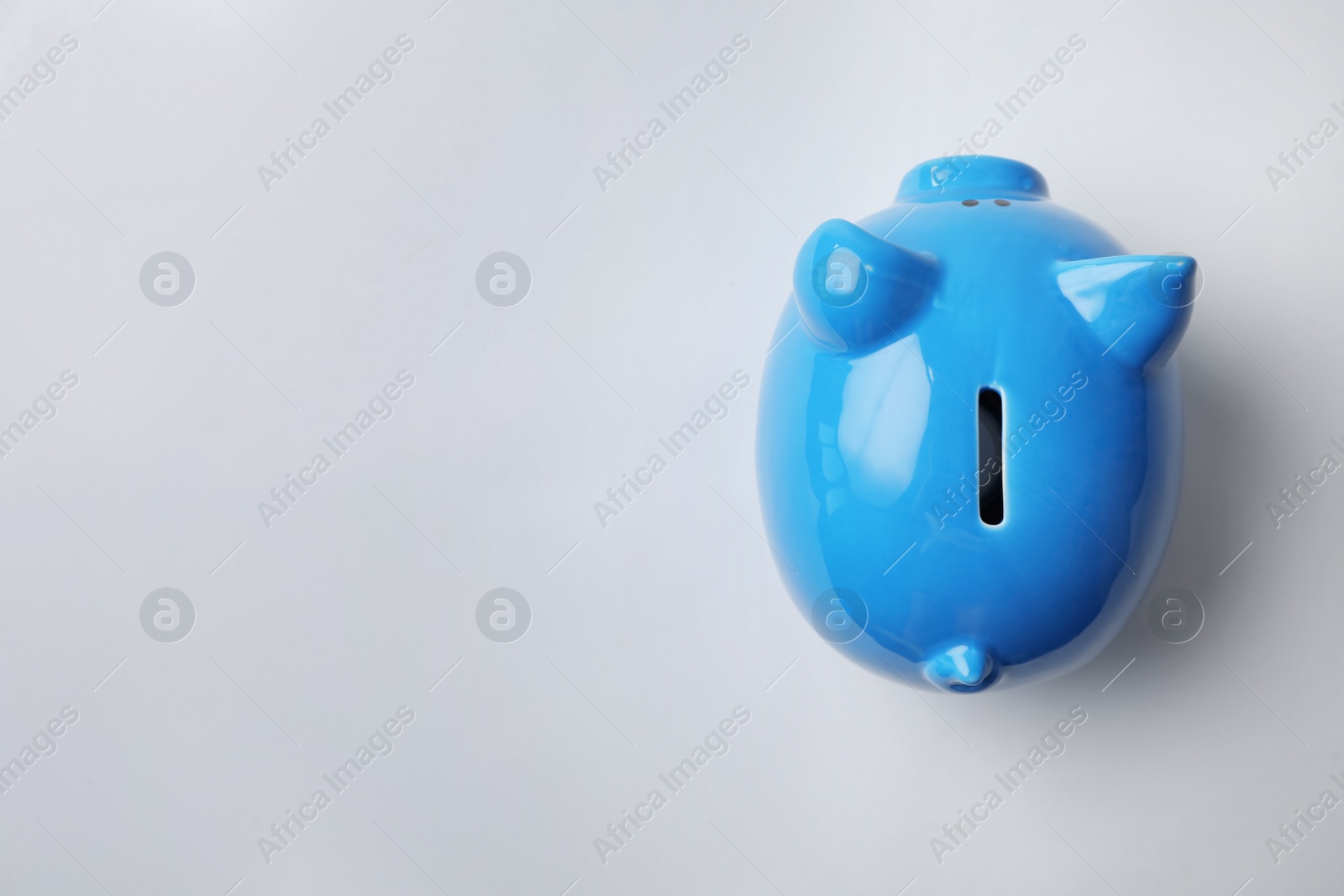 Photo of Blue piggy bank on white background, top view