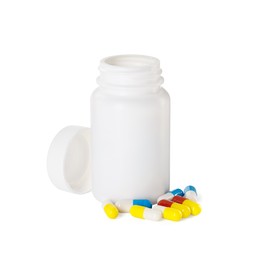 Photo of Antibiotic pills and bottle isolated on white