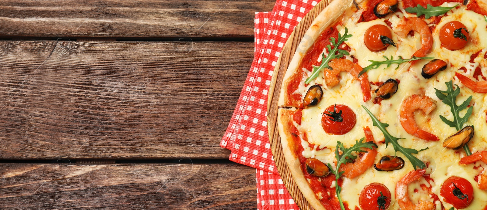 Image of Top view of hot delicious pizza on wooden table, space for text. Banner design 