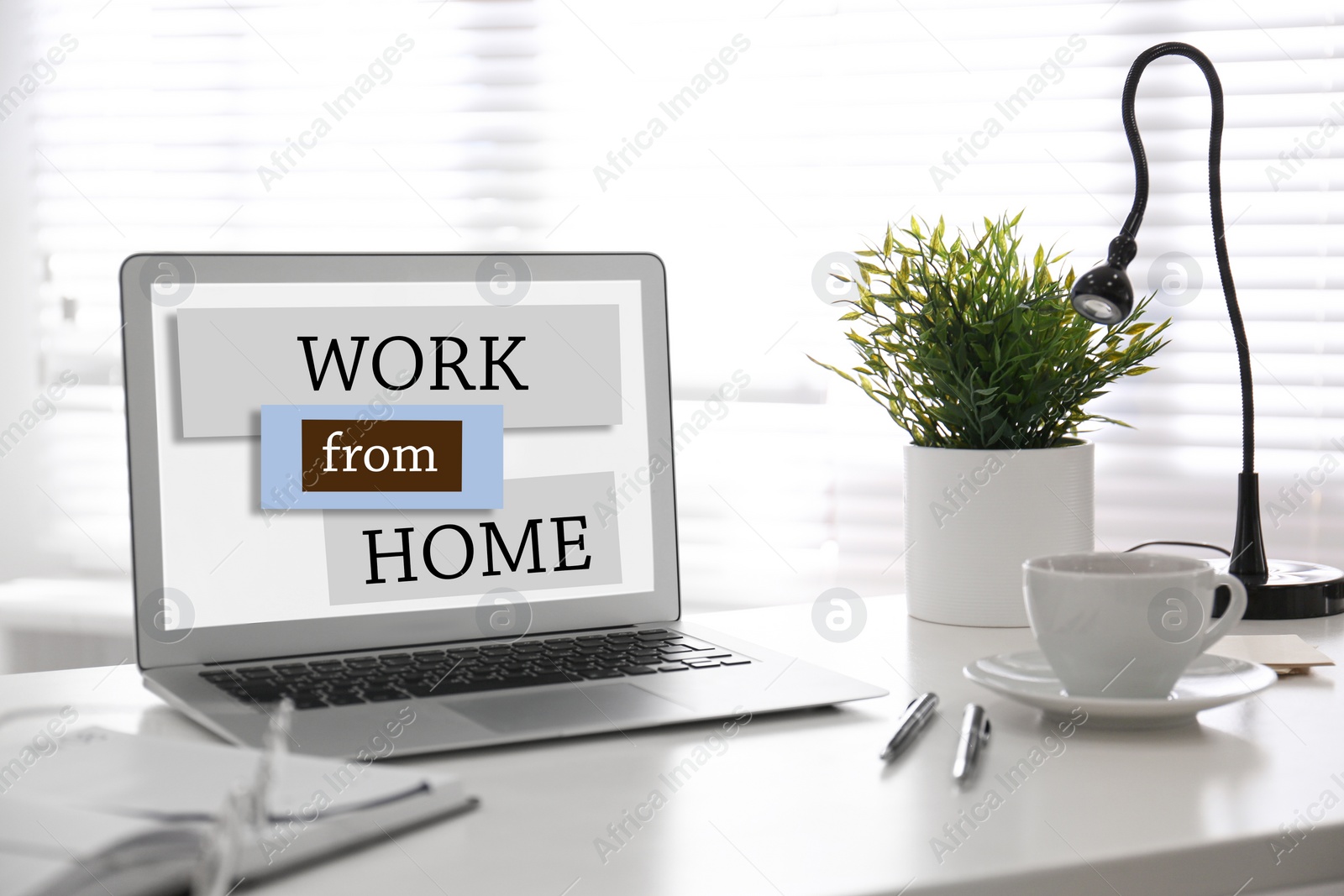 Image of Modern laptop on table in room. Work from home