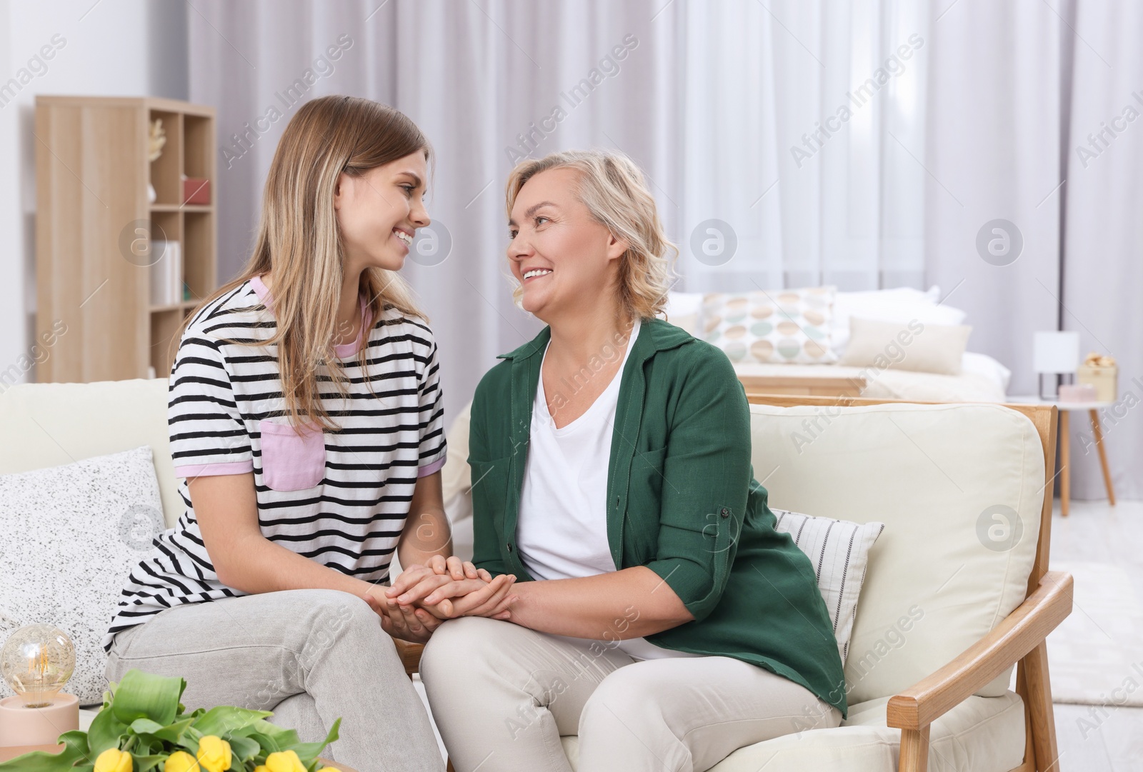 Photo of Young daughter congratulating her mom at home. Happy Mother's Day