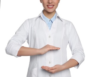 Photo of Beautiful young doctor holding something on white background, closeup