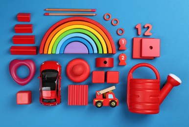 Different children's toys on blue background, flat lay