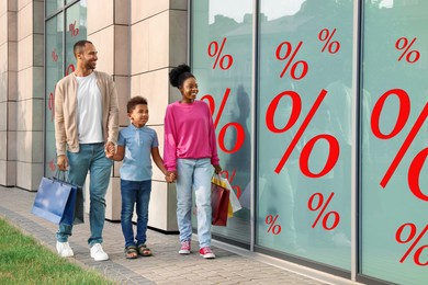 Image of Discount offer. Family with shopping bags walking to store. Window glass with percent signs