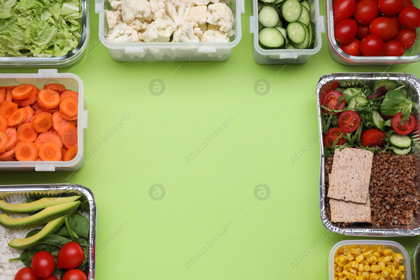 Photo of Different containers with fresh products on light green background, flat lay. Space for text