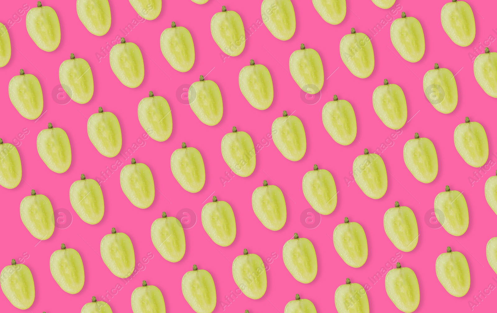 Image of Pattern of grape halves on bright pink background