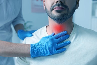 Endocrinologist examining thyroid gland of patient at hospital, closeup