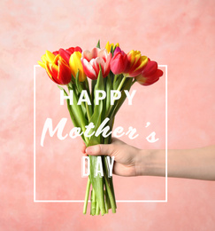 Image of Woman with bouquet of tulips and phrase HAPPY MOTHER'S DAY on light pink background, closeup