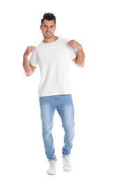 Photo of Young man in t-shirt on white background. Mockup for design