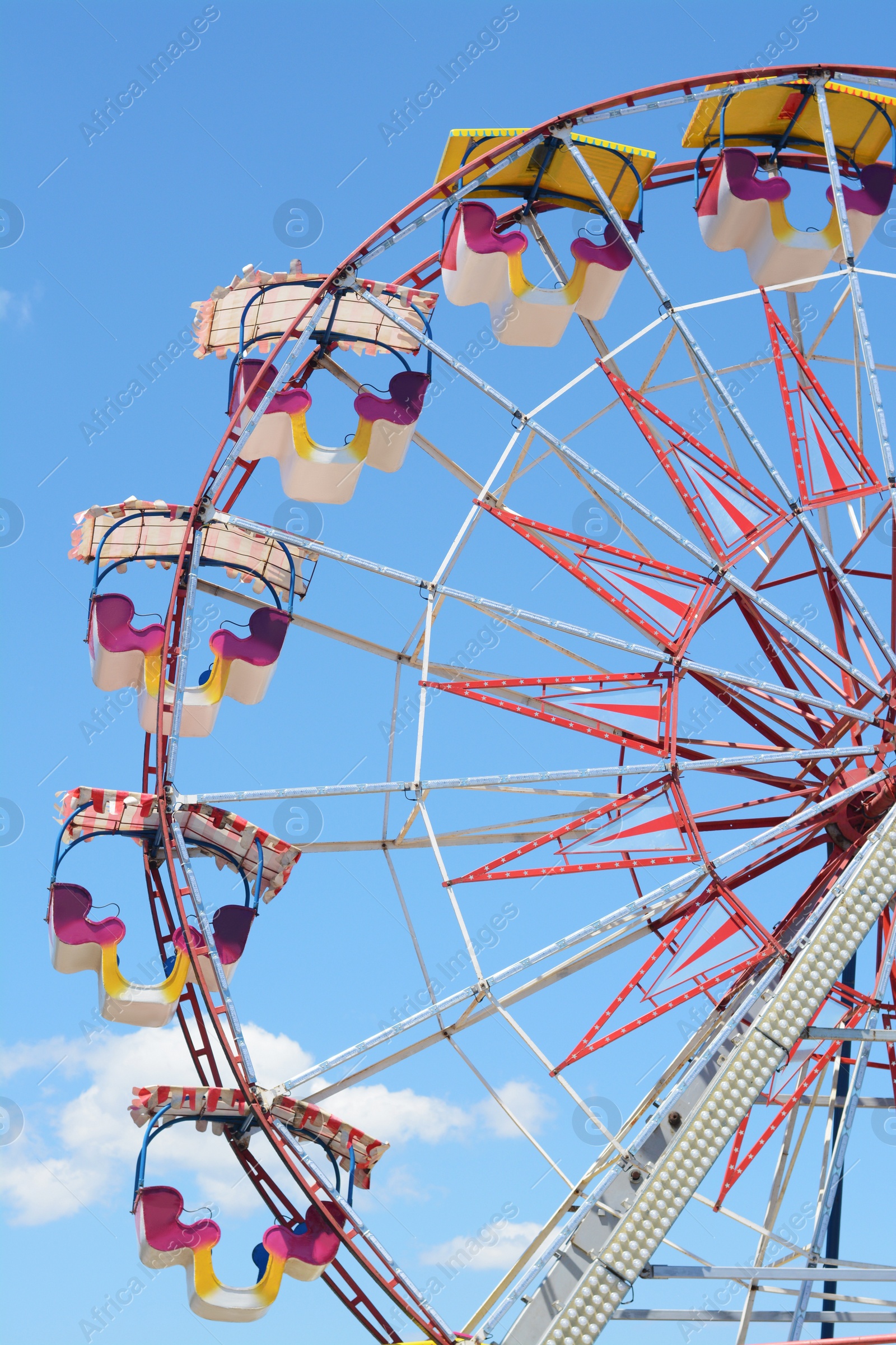 Photo of Large empty observation wheel against blue sky