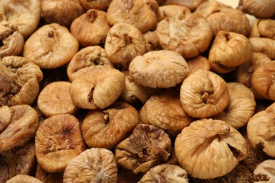 Many tasty dried figs as background, closeup