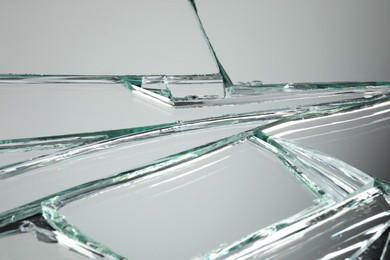 Broken mirror with many cracks as background, closeup view