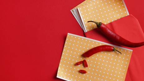 Photo of Pepper plasters and chili on red background, flat lay. Space for text
