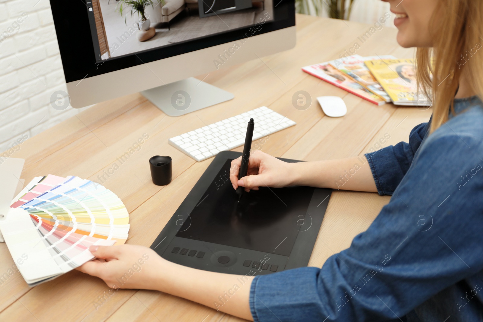 Photo of Professional retoucher working on graphic tablet at desk, closeup