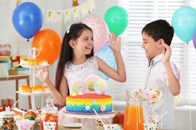 Happy children at birthday party in decorated room