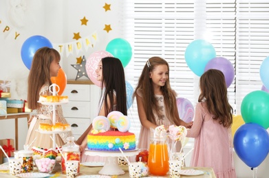 Photo of Happy children having fun at birthday party indoors