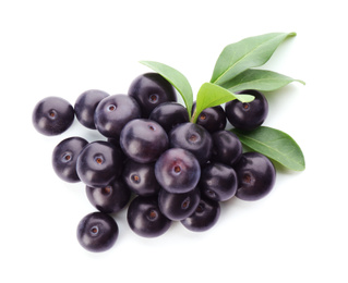 Photo of Pile of fresh acai berries with leaves isolated on white, top view