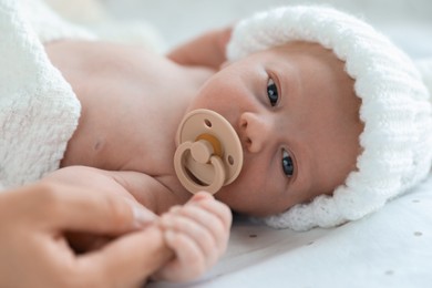 Photo of Mother and her cute newborn baby on bed, closeup