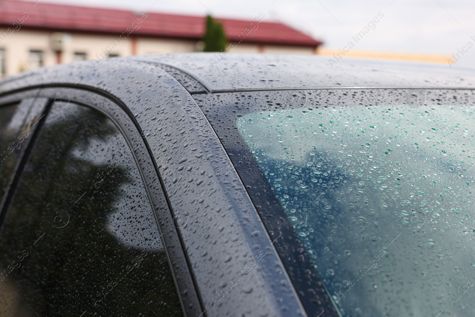 Photo of Modern car with windows in water drops outdoors, closeup