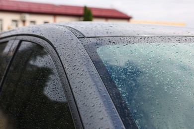 Photo of Modern car with windows in water drops outdoors, closeup