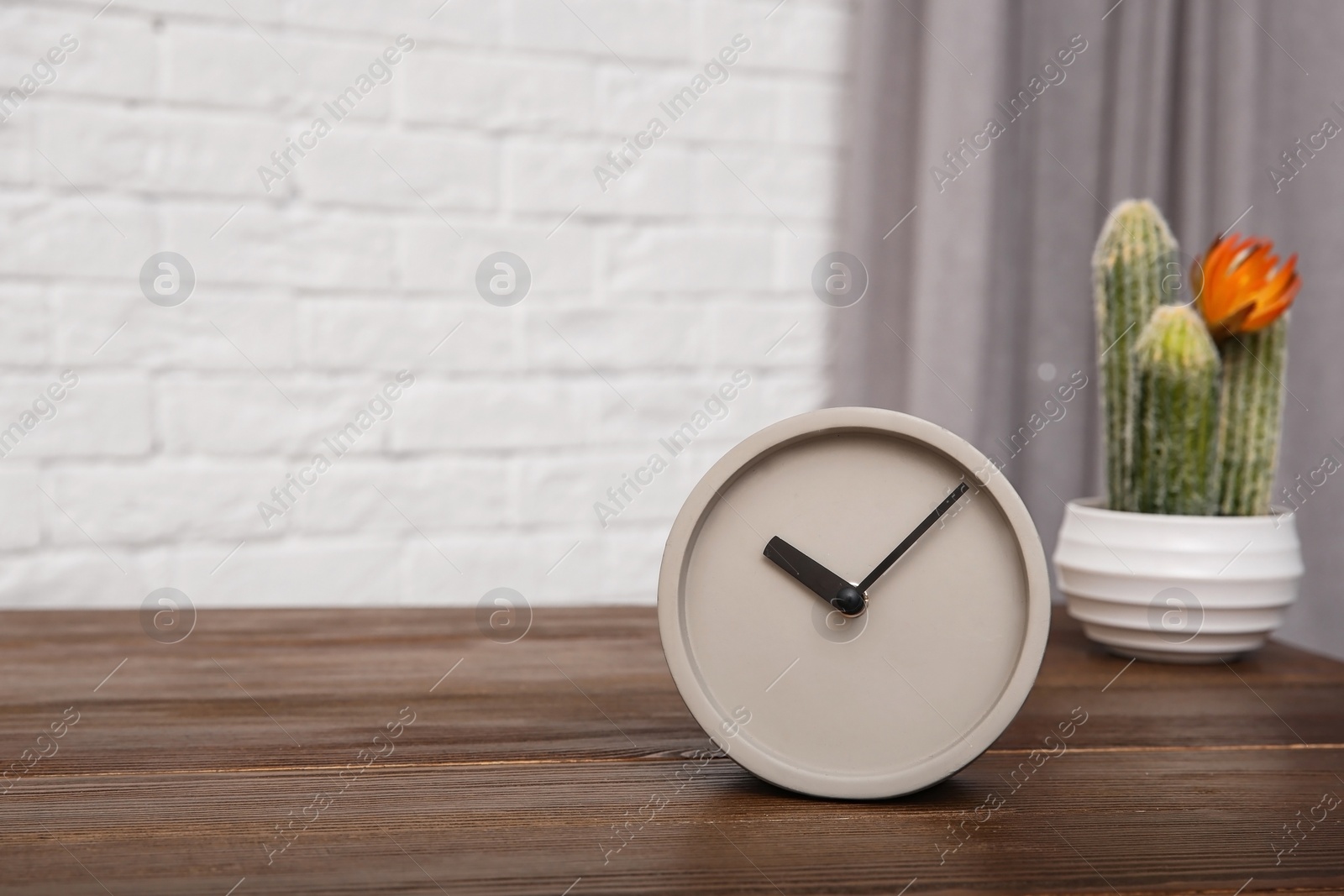 Photo of Modern alarm clock on table indoors. Space for text