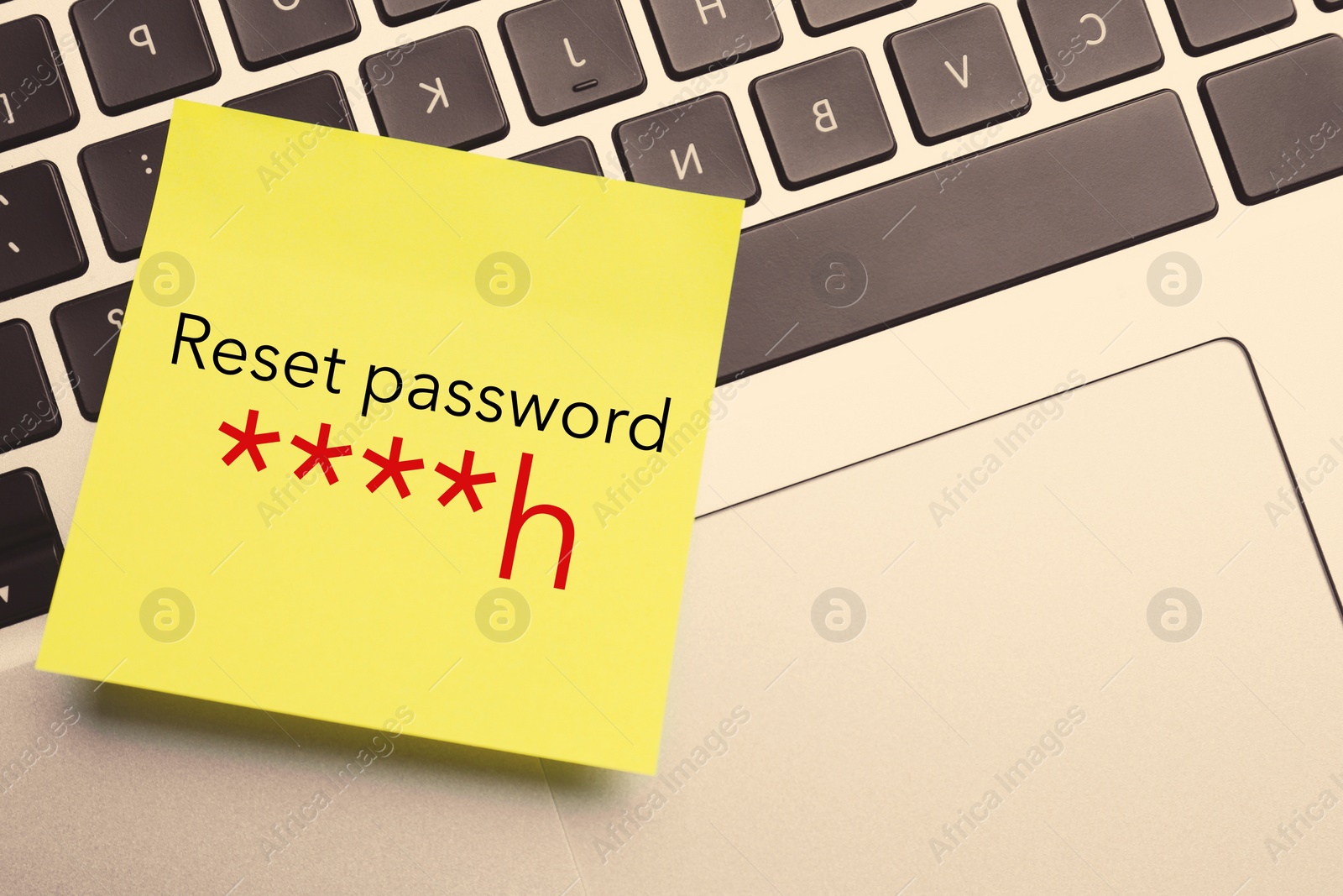 Image of Sticky note with phrase Reset Password on laptop, top view