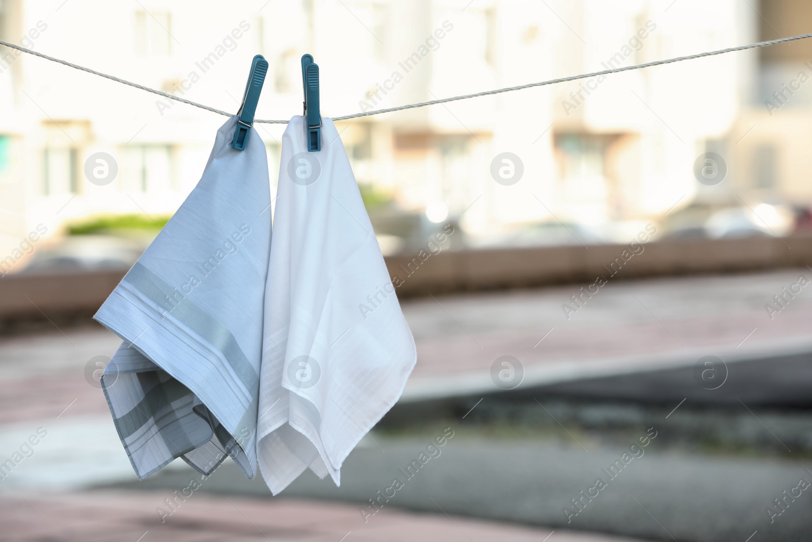 Photo of Handkerchiefs hanging on rope outdoors, space for text