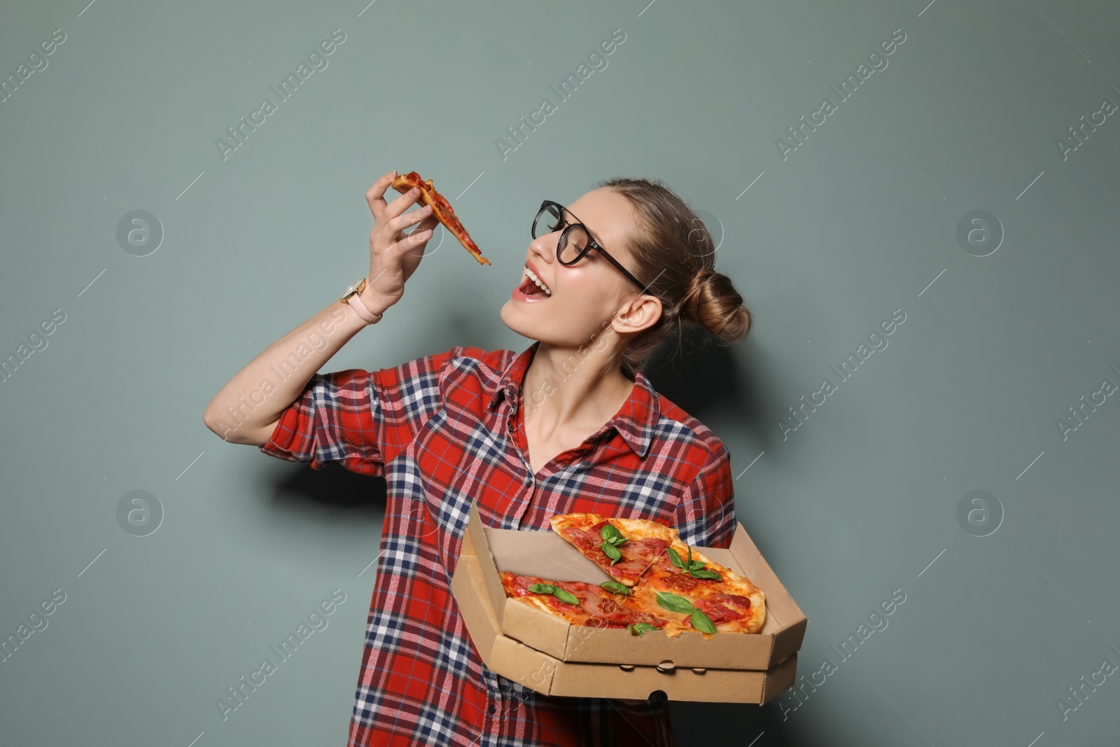 Photo of Attractive young woman with delicious pizza on color background