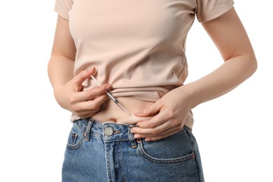 Photo of Diabetes. Woman making insulin injection into her belly on white background, closeup