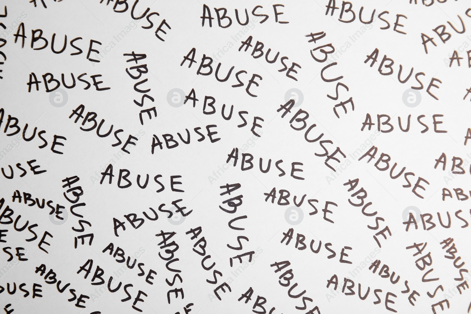 Photo of Sheet of paper with words ABUSE, top view. Domestic violence awareness