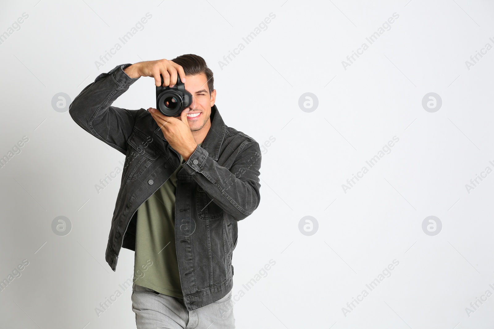 Photo of Professional photographer working on white background in studio