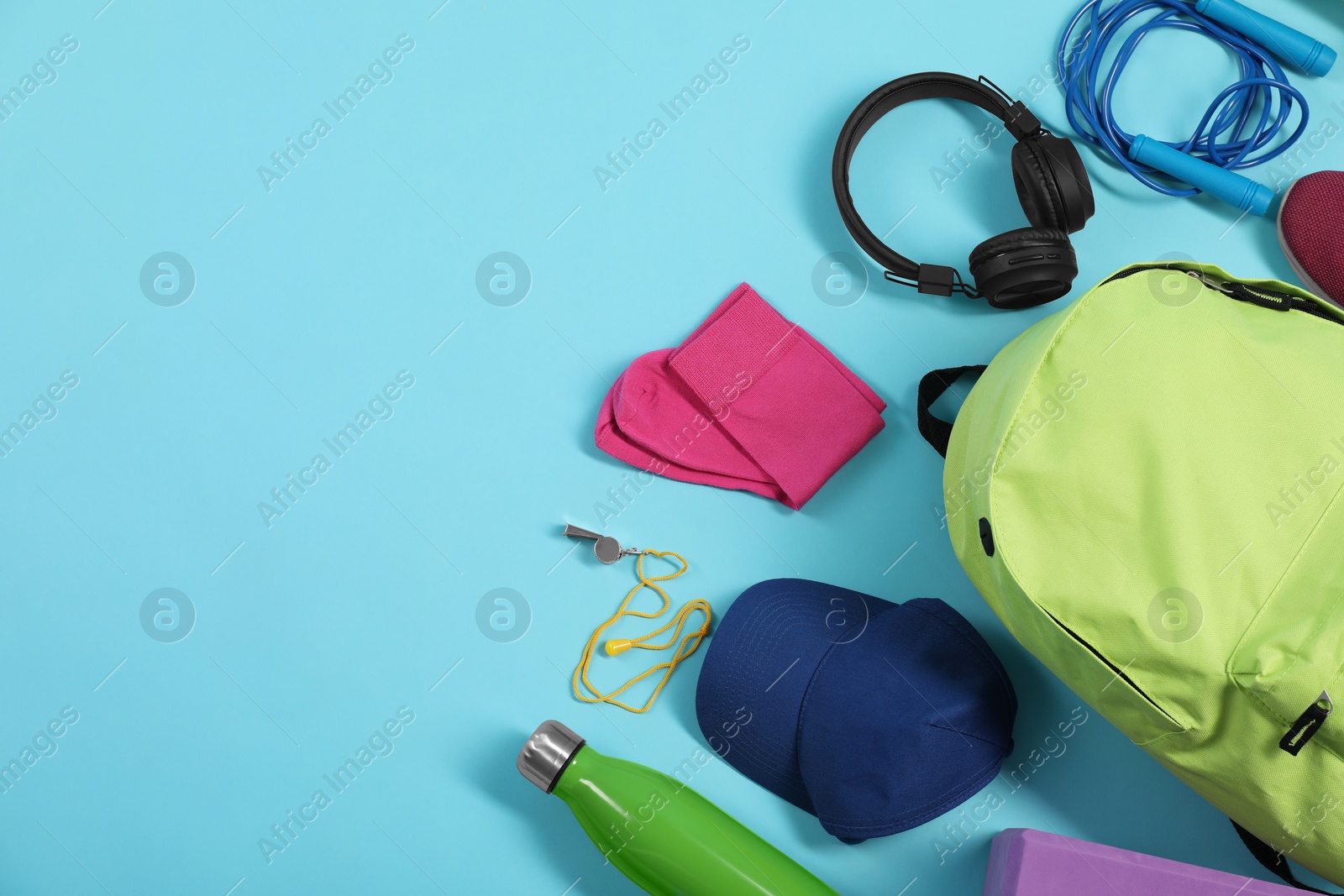 Photo of Different sports equipment on light blue background, flat lay. Space for text