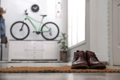 Photo of Hallway interior with stylish furniture and bicycle, focus on shoes