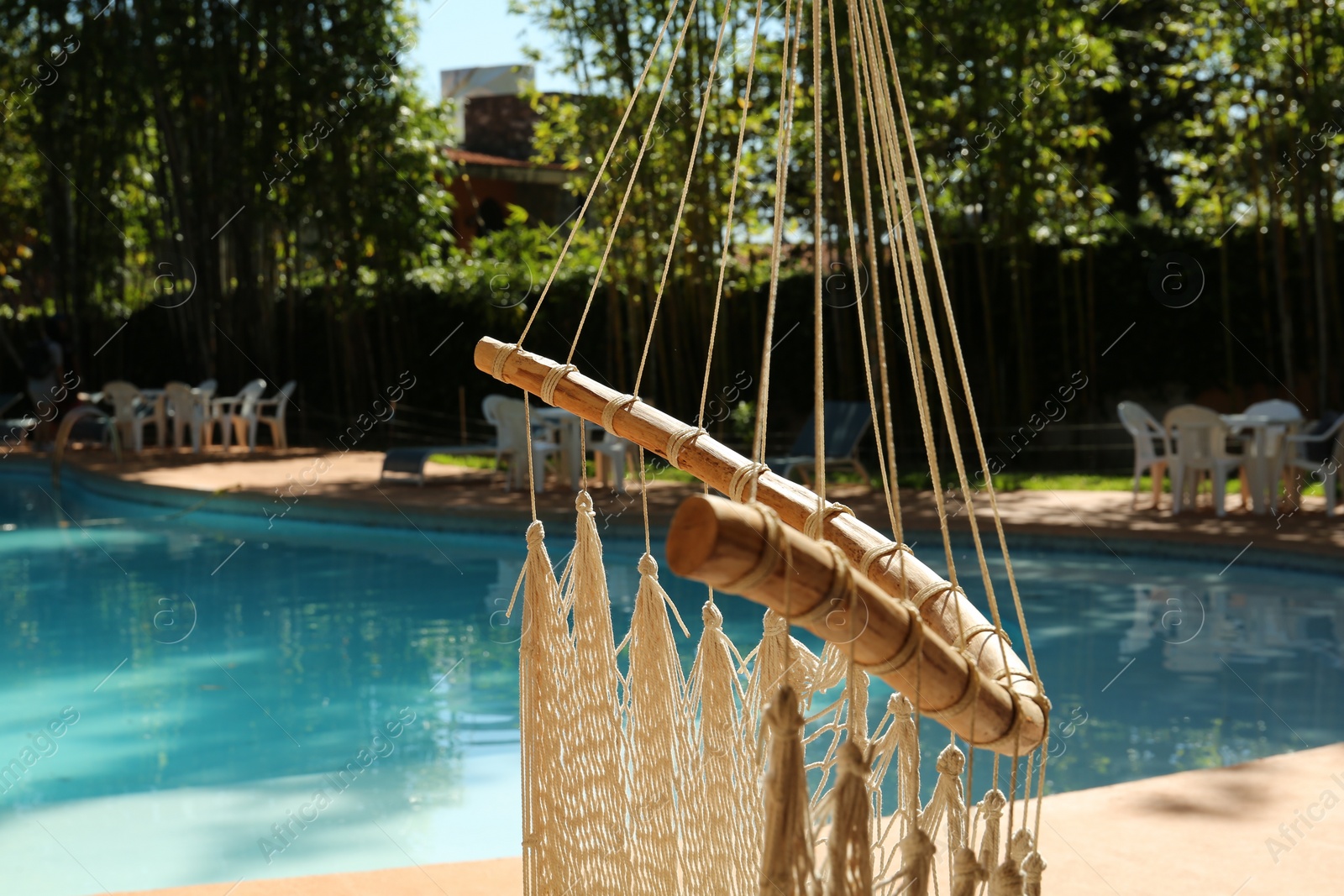 Photo of Hammock near pool with clean water outdoors, closeup