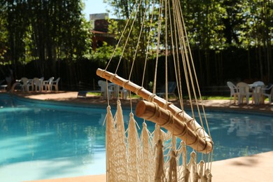 Hammock near pool with clean water outdoors, closeup